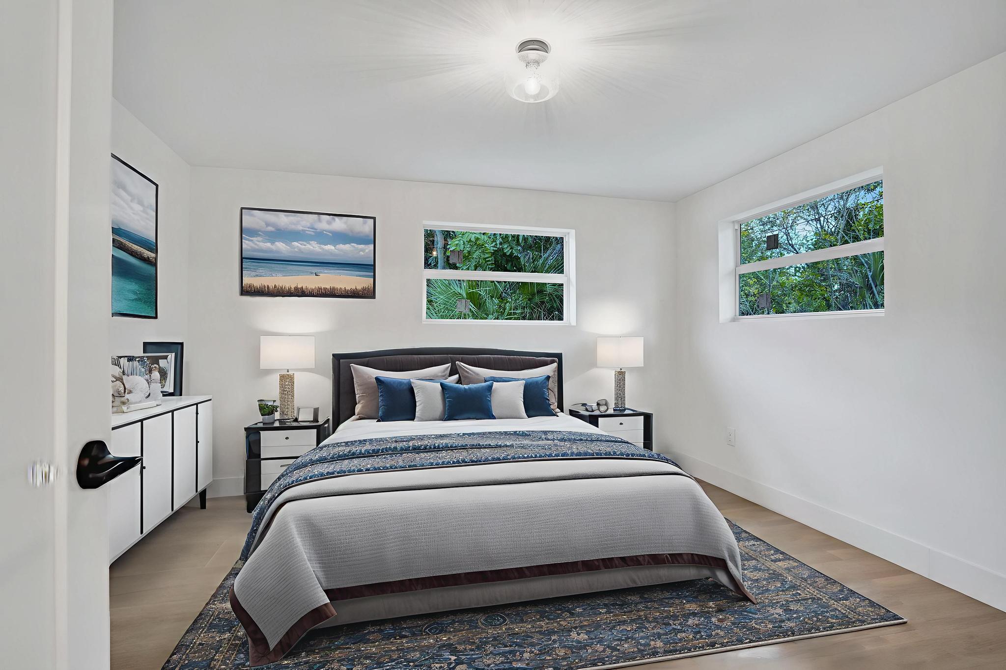 200 Northwest 2nd Street Delray Beach, FL 33444 - Photo 29 of 44 a bedroom with a bed a painting on the wall and a window