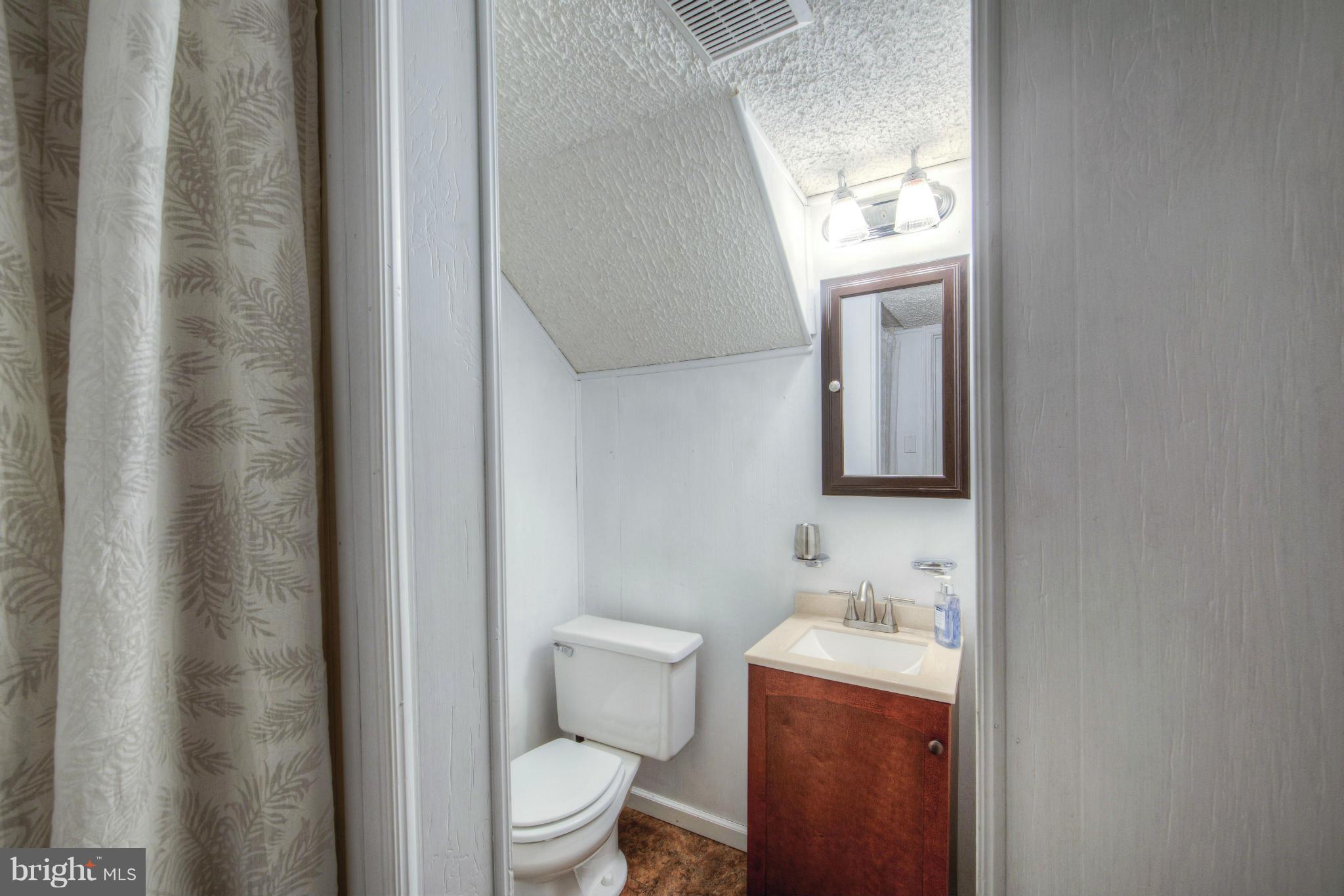 55 Buck Road Stafford, VA 22556 - Photo 14 of 19 a bathroom with a toilet sink and mirror