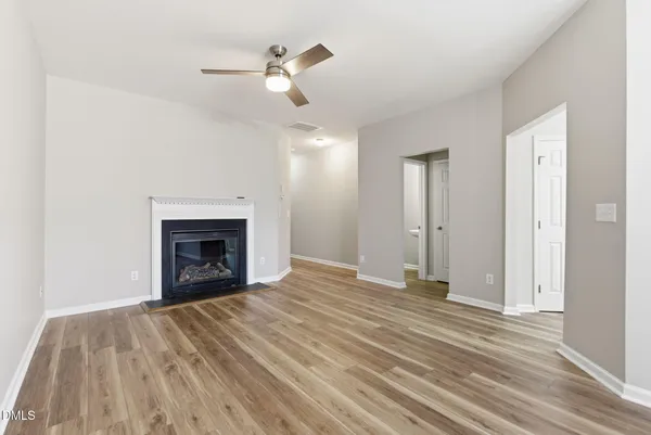 wooden floor fireplace and natural light in room