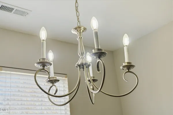 a bathroom with light fixture a mirror and a ceiling fan
