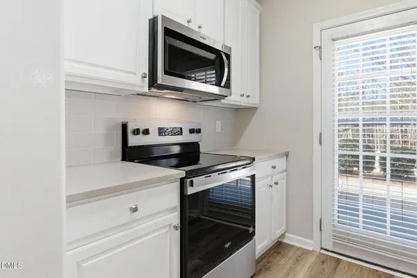 a kitchen with a stove and a microwave