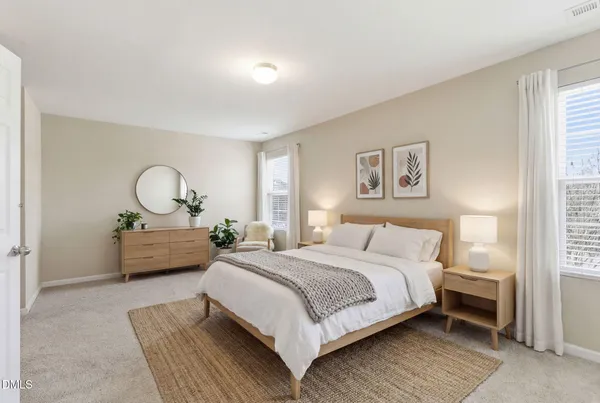 a bedroom with a bed mirror and window