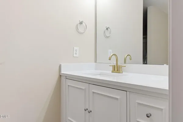 a bathroom with a sink and vanity