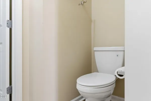 a white toilet sitting next to a shower