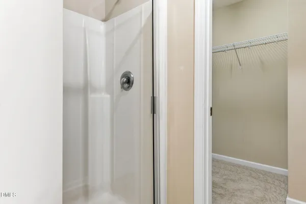 a bathroom with a glass shower door