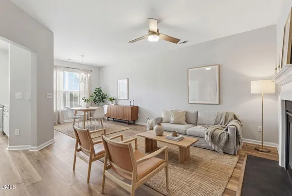 a living room with furniture and a chandelier