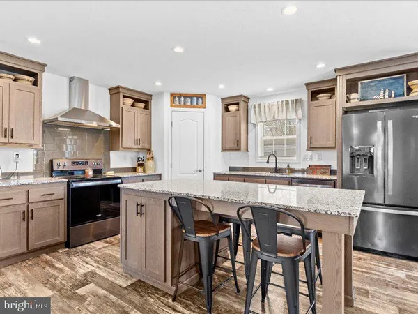 a kitchen with a table chairs refrigerator and cabinets