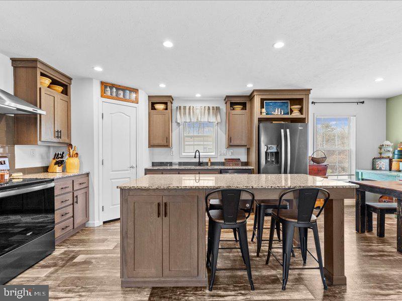501 Windy Hill Road Shermans Dale, PA 17090 - Photo 10 of 26 a large kitchen with granite countertop a stove a sink a dining table and chairs