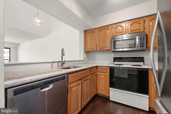 a kitchen with stainless steel appliances granite countertop a stove top oven a sink and dishwasher