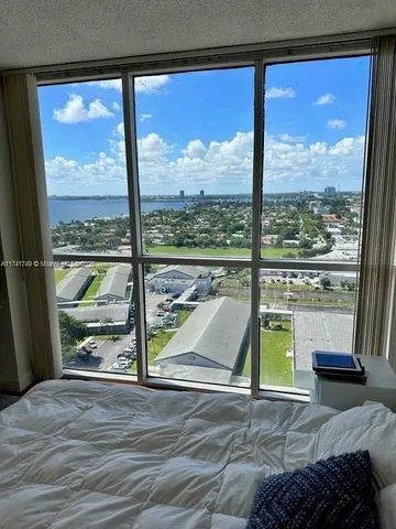 a view of a porch with a floor to ceiling window next to a yard