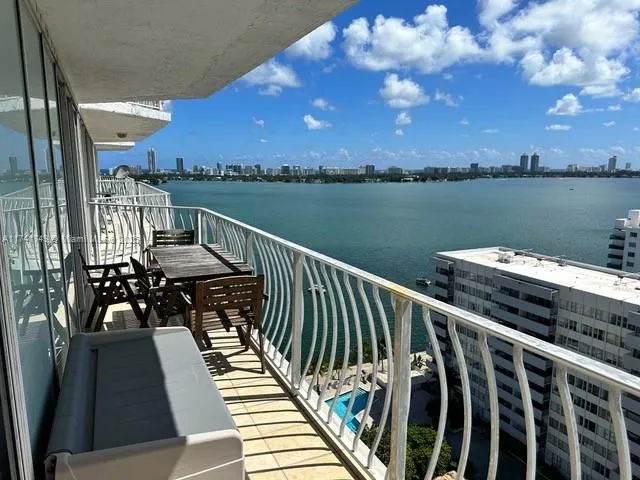 a view of a balcony with wooden floor and city view