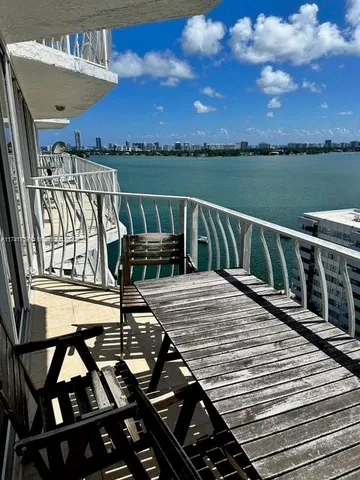 a view of balcony with wooden floor and lake view