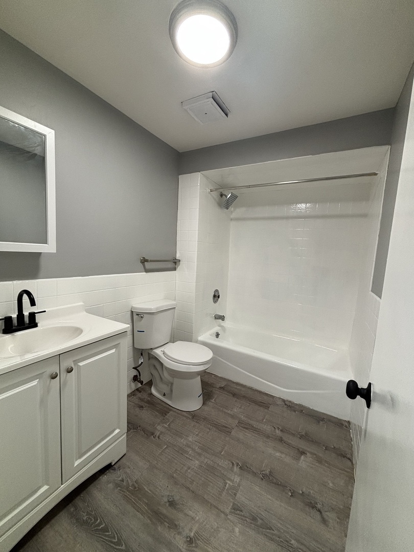 10401 South Ewing Avenue, Unit 104032 Chicago, IL 60617 - Photo 7 of 10 a bathroom with a sink a toilet and shower