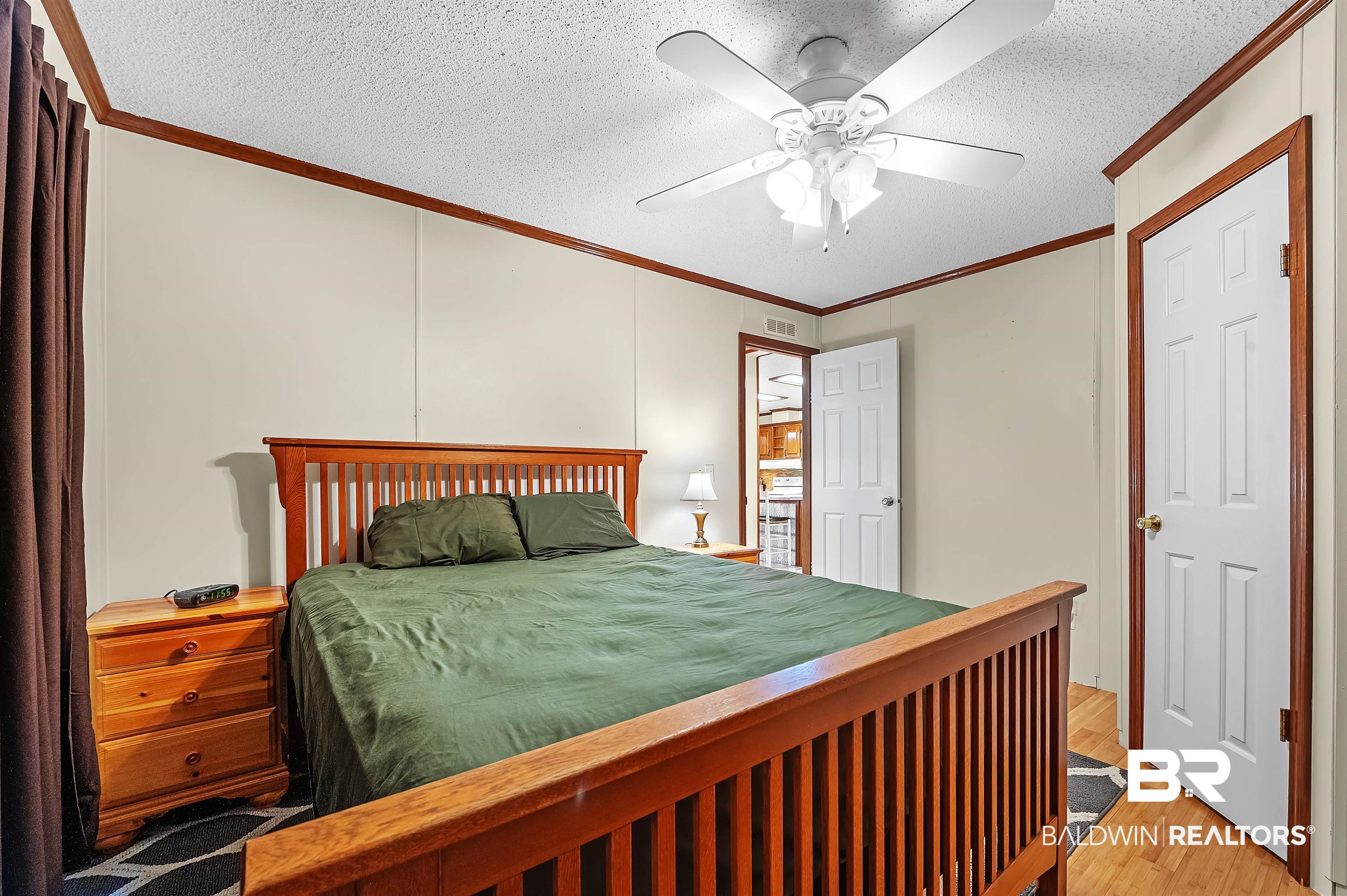10970 Stucki Road Elberta, AL 36530 - Photo 36 of 56 Bedroom featuring crown molding, Bamboo flooring, ceiling fan, and a textured ceiling