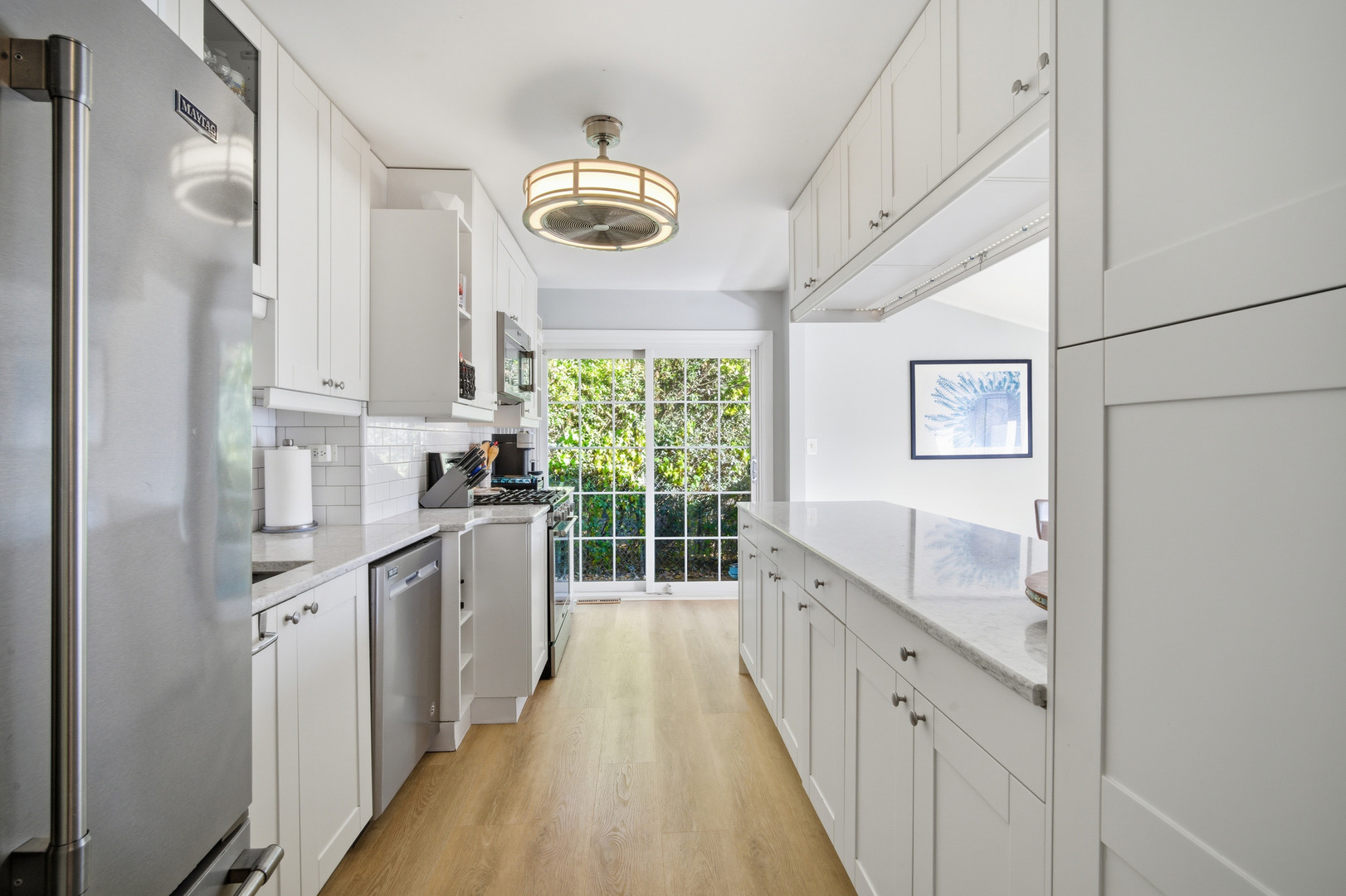 484 Chatham Circle Buffalo Grove, IL 60089 - Photo 12 of 28 a kitchen with stainless steel appliances a large window and a refrigerator