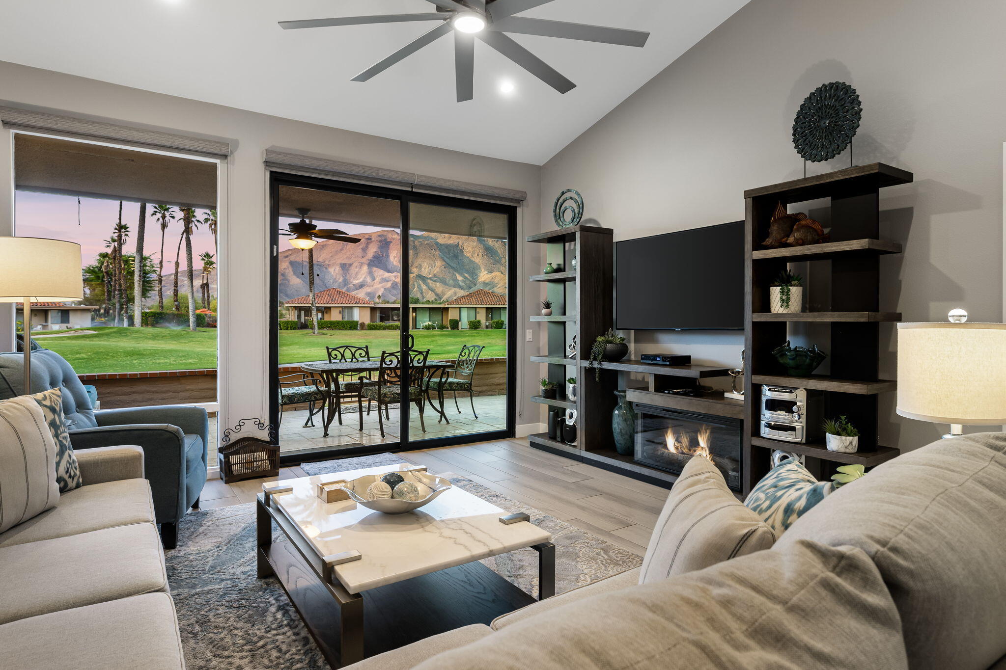 10 Palma Drive Rancho Mirage, CA 92270 - Photo 11 of 51 a living room with furniture a floor to ceiling window and a flat screen tv