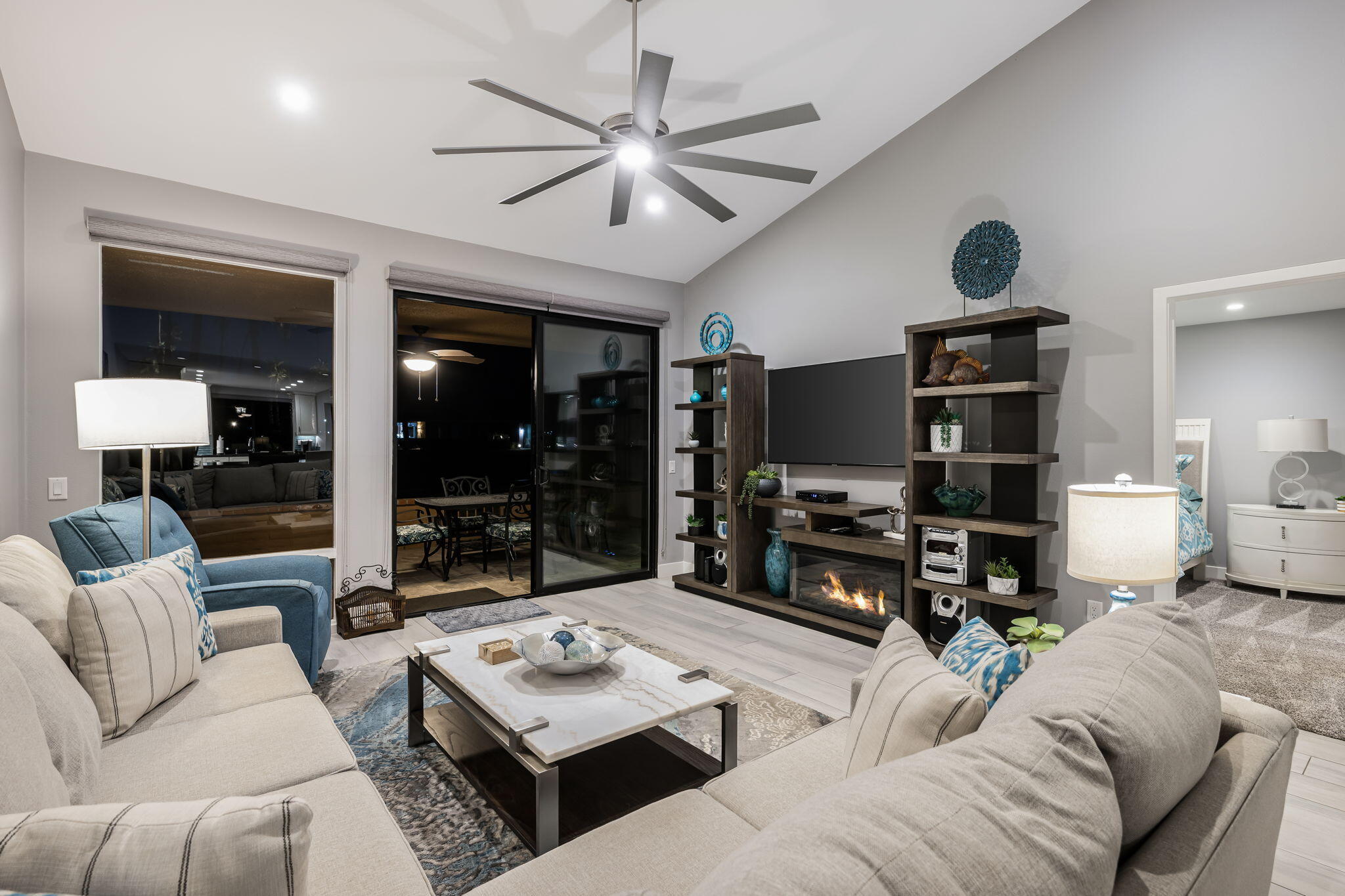 10 Palma Drive Rancho Mirage, CA 92270 - Photo 12 of 51 a living room with furniture a flat screen tv and a floor to ceiling window