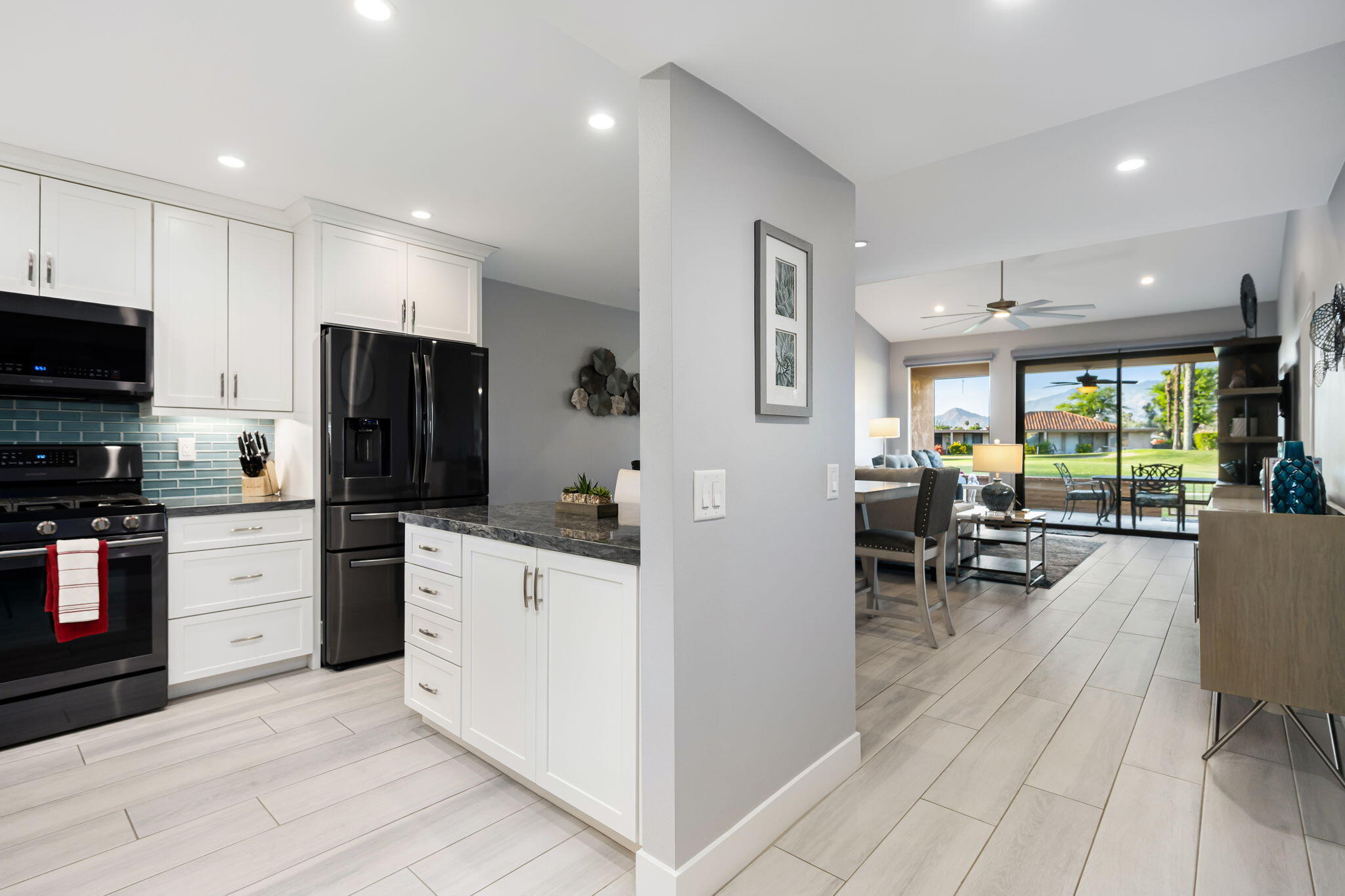 10 Palma Drive Rancho Mirage, CA 92270 - Photo 15 of 51 a kitchen with white cabinets and stainless steel appliances