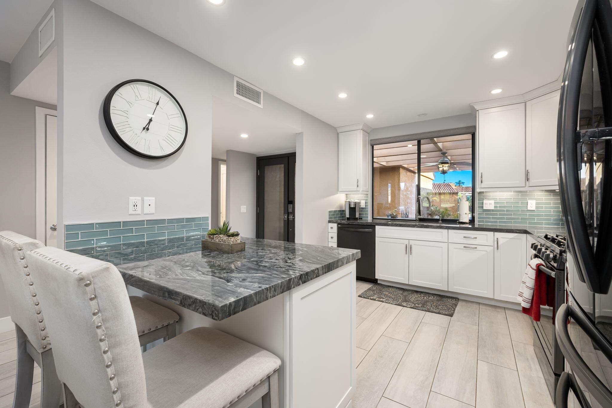 10 Palma Drive Rancho Mirage, CA 92270 - Photo 18 of 51 a kitchen with stainless steel appliances granite countertop a stove and white cabinets