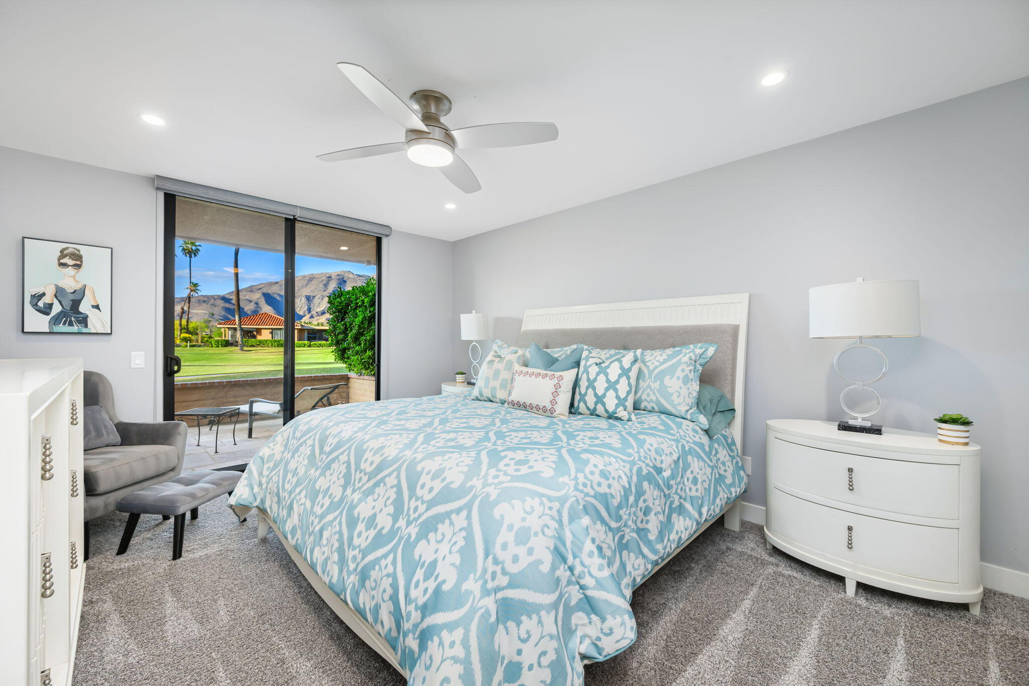 10 Palma Drive Rancho Mirage, CA 92270 - Photo 22 of 51 a bedroom with a bed and a chandelier