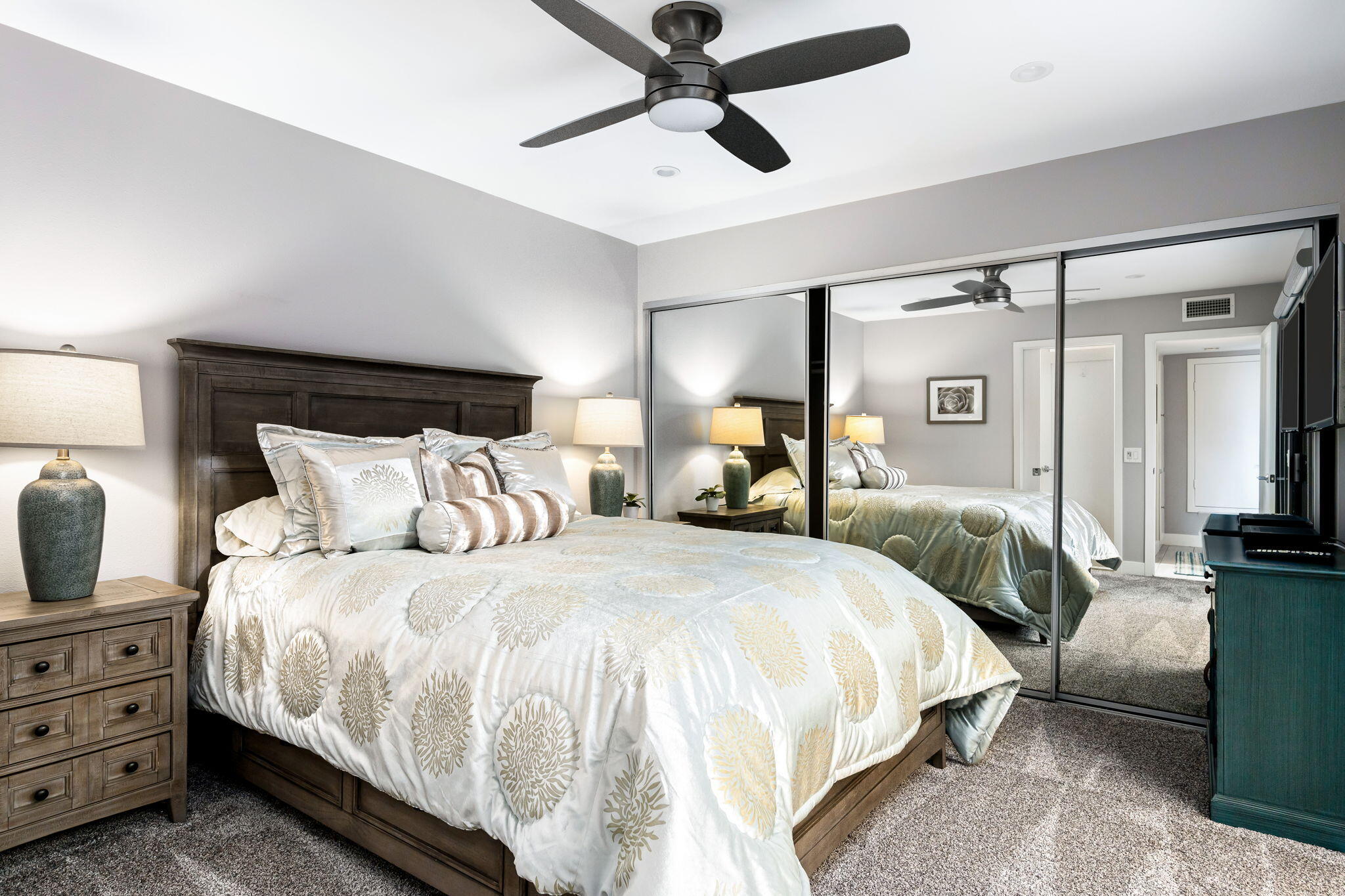 10 Palma Drive Rancho Mirage, CA 92270 - Photo 26 of 51 a bedroom with bed and a chandelier