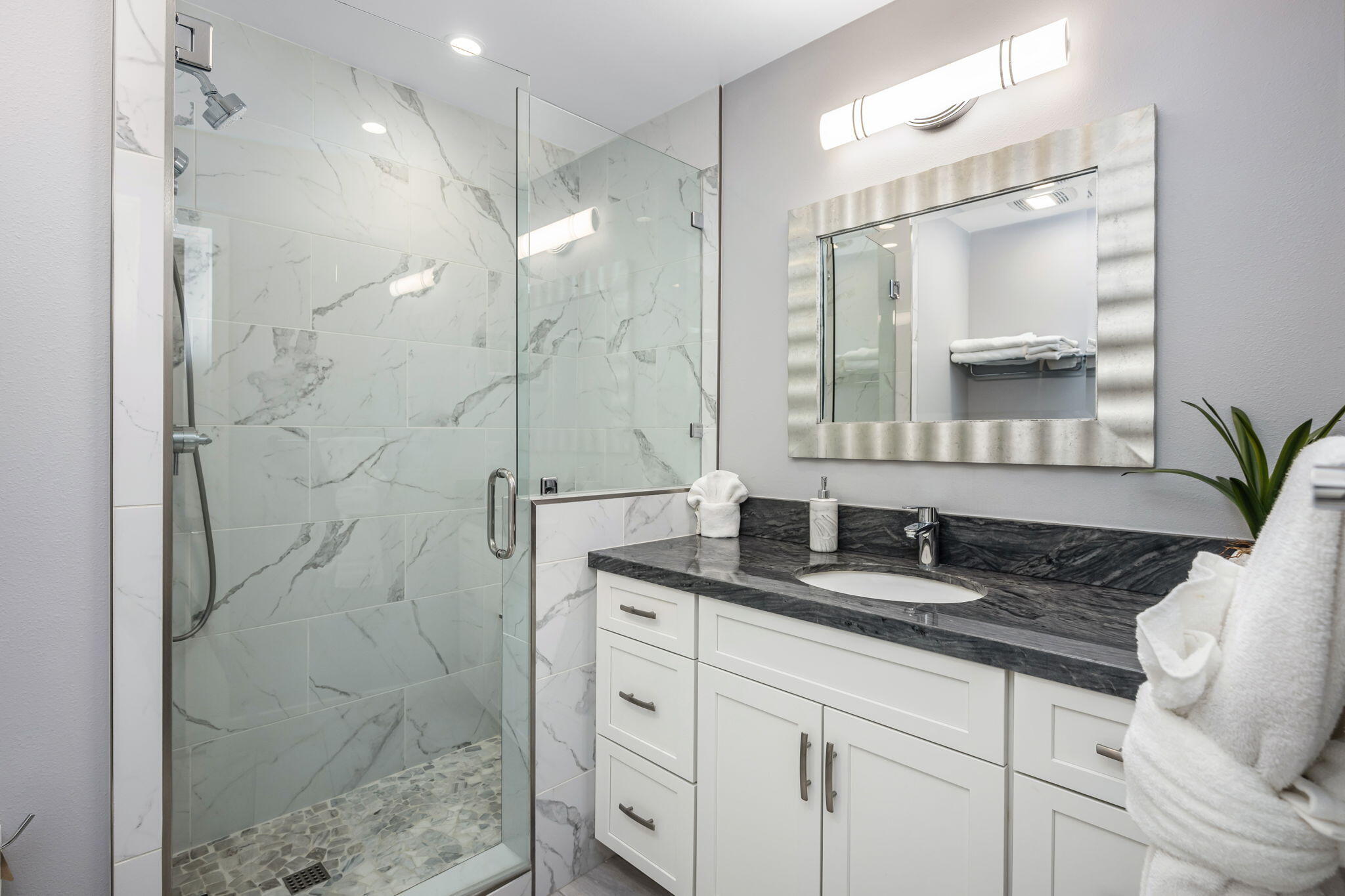10 Palma Drive Rancho Mirage, CA 92270 - Photo 28 of 51 a bathroom with a granite countertop sink a mirror and shower