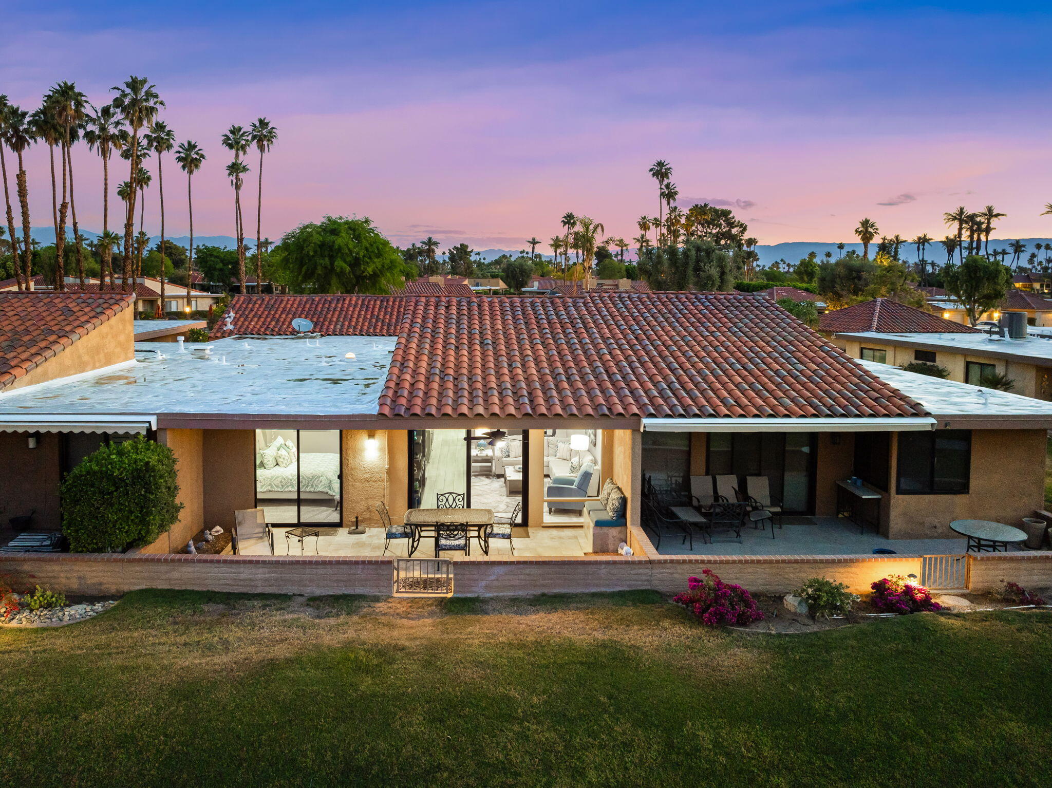 10 Palma Drive Rancho Mirage, CA 92270 - Photo 32 of 51 a front view of a house with swimming pool having outdoor seating