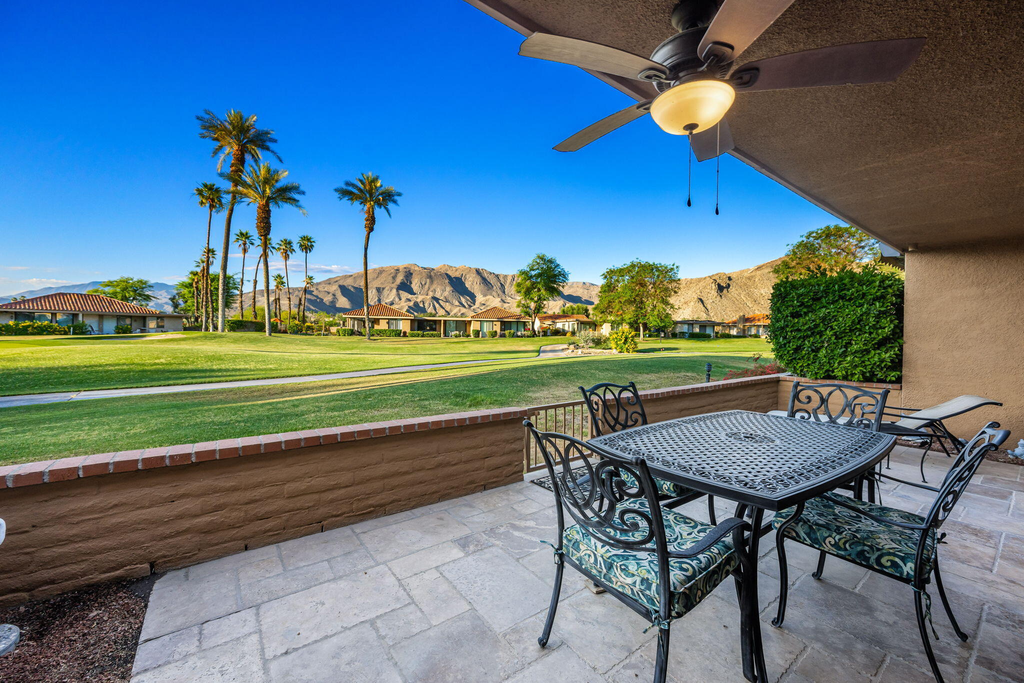 10 Palma Drive Rancho Mirage, CA 92270 - Photo 35 of 51 a view of a chairs and table in patio with a yard