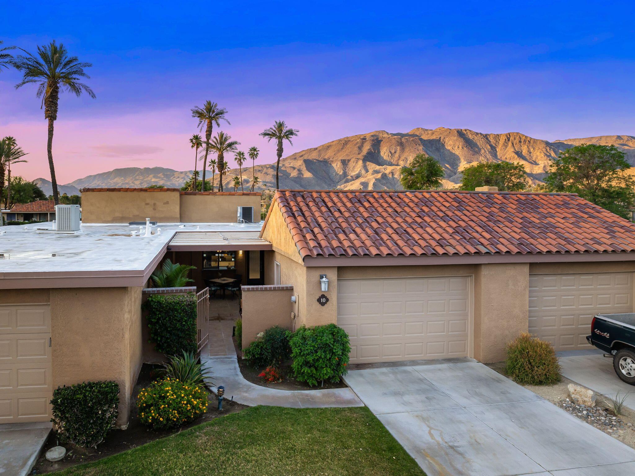 10 Palma Drive Rancho Mirage, CA 92270 - Photo 38 of 51 a front view of a house with a garden and lake view