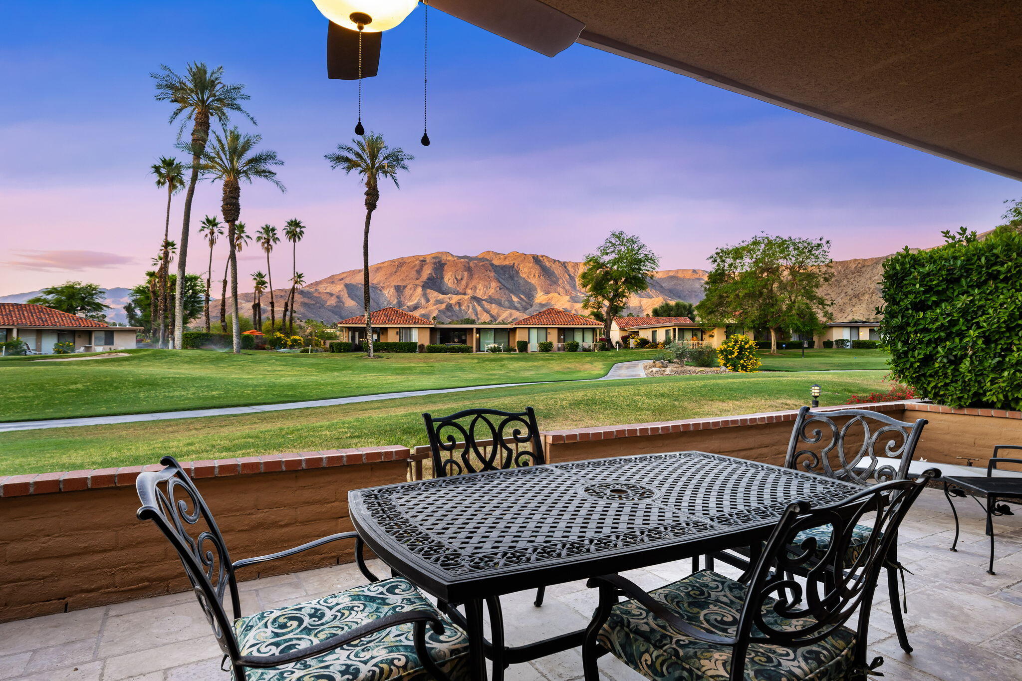10 Palma Drive Rancho Mirage, CA 92270 - Photo 39 of 51 a view of a patio with a table chairs and a swimming pool