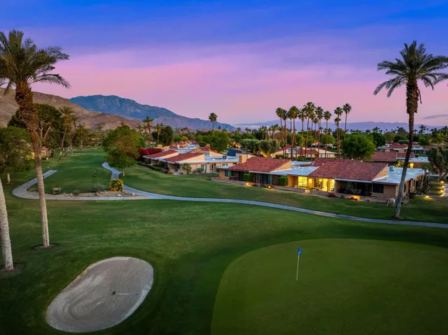a view of a lake with a houses in the background