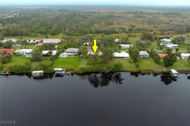 an aerial view of a houses with yard