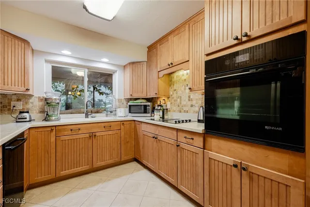 a kitchen with stainless steel appliances granite countertop wooden cabinets a sink and a stove