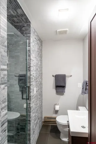 a bathroom with a toilet and a shower