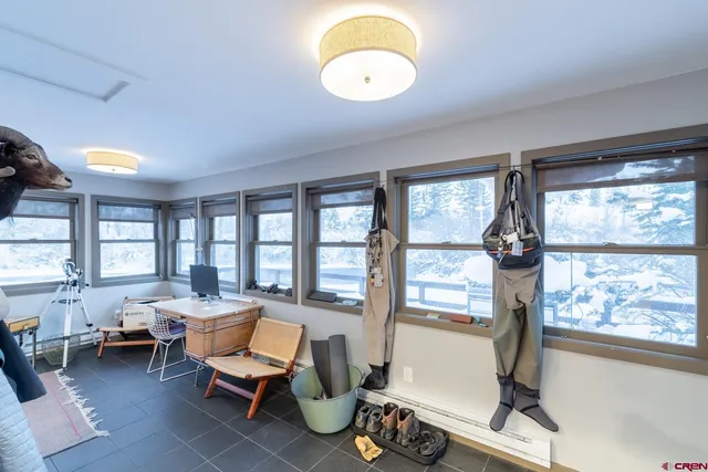 a living room with furniture and a floor to ceiling window