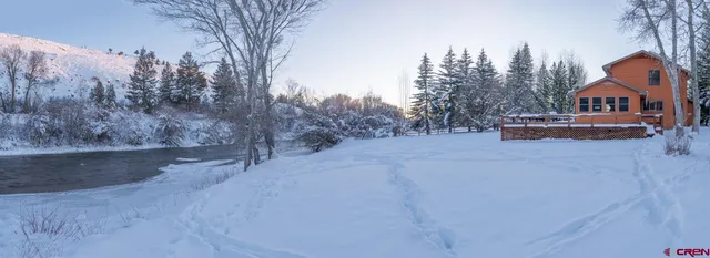 a front view of a house with a yard and table and chairs