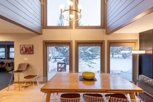 a view of a dining room with furniture and a floor to ceiling window