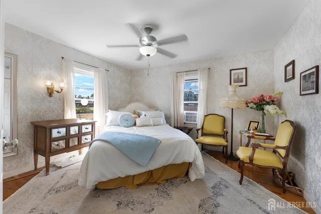 a bedroom with a bed chairs and window