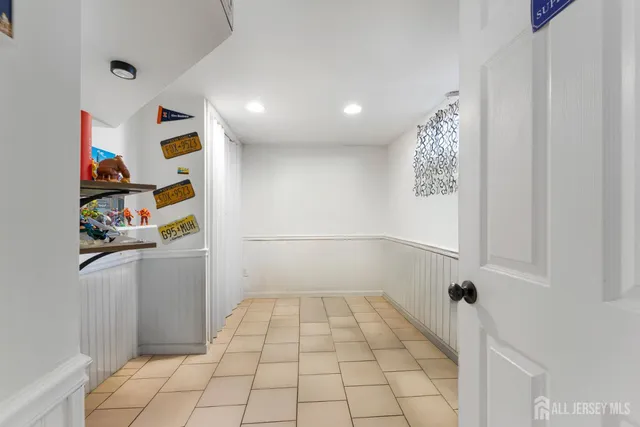 a bathroom with a granite countertop toilet sink and mirror