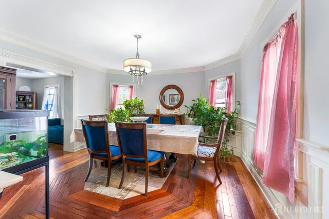 a dining room with furniture a window and wooden floor