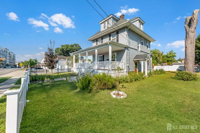 a front view of a house with a yard table and chairs