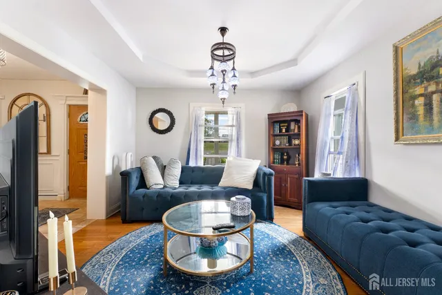 a living room with furniture and a chandelier