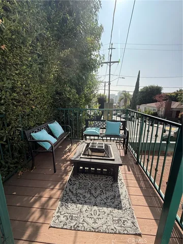 a front view of a house with barbeque and wooden floor