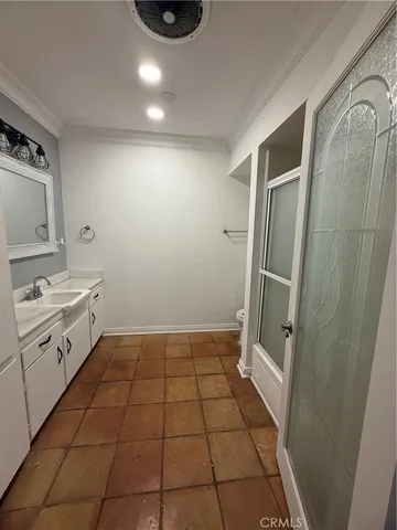 a bathroom with a sink a toilet and a shower