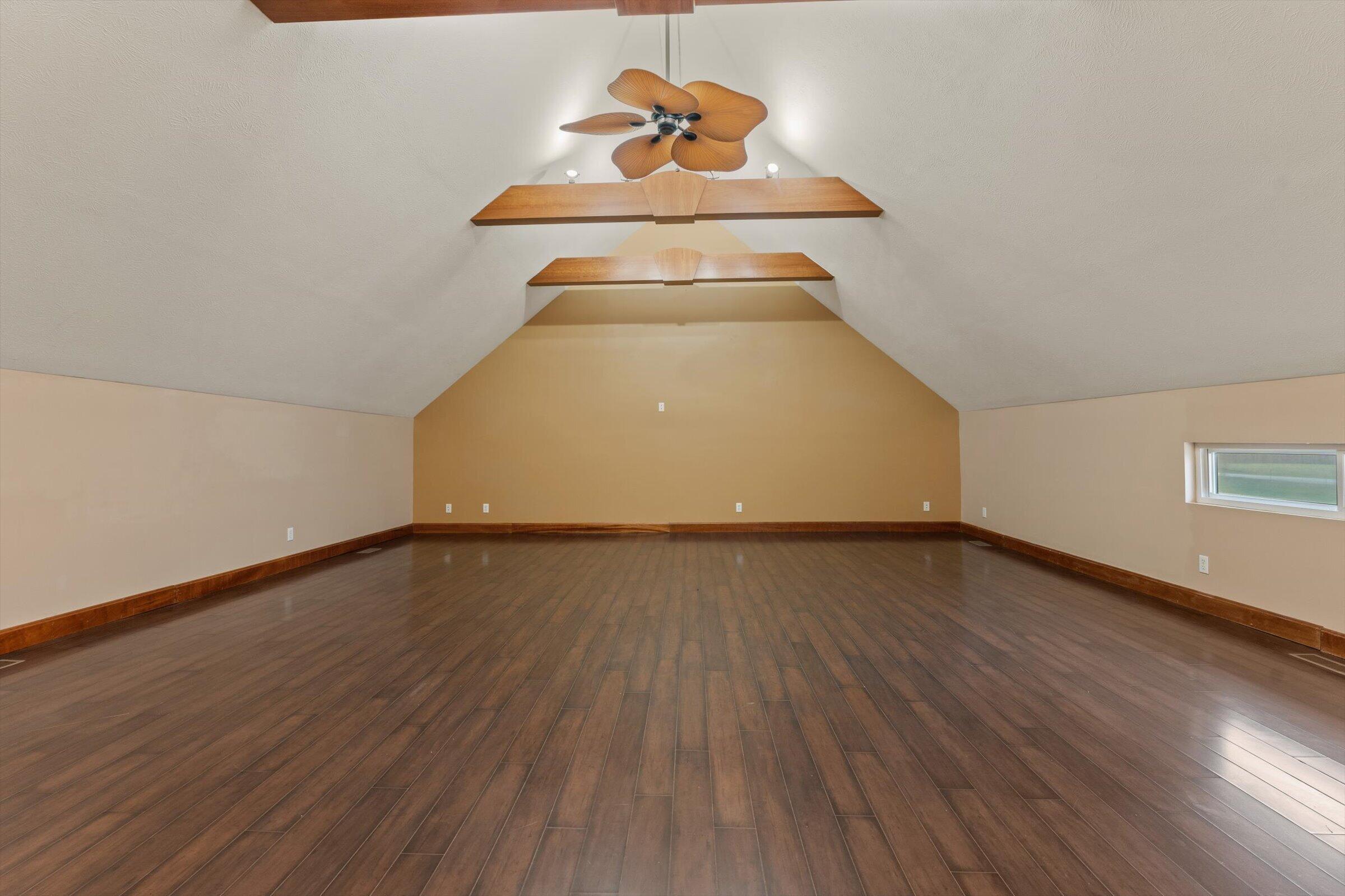 7692 North Emery Road Rolling Prairie, IN 46371 - Photo 30 of 69 a view of a hallway with wooden floor and a chandelier