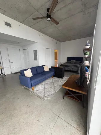 a living room with furniture and a piano
