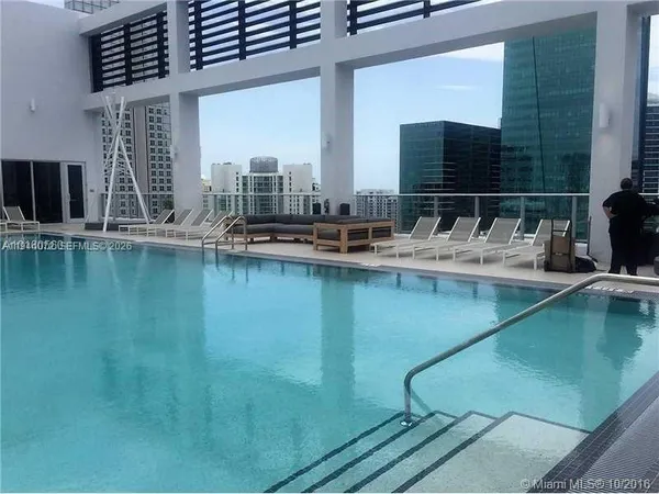 a view of a swimming pool with outdoor seating