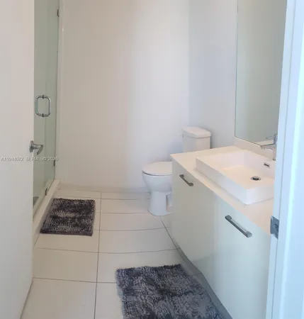 a bathroom with a sink a toilet and a shower