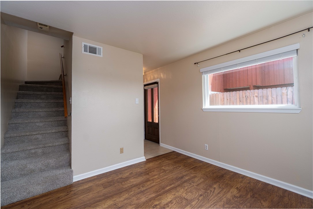 6232 Weber Road Corpus Christi, TX 78413 - Photo 14 of 23 a view of an empty room with wooden floor and a window