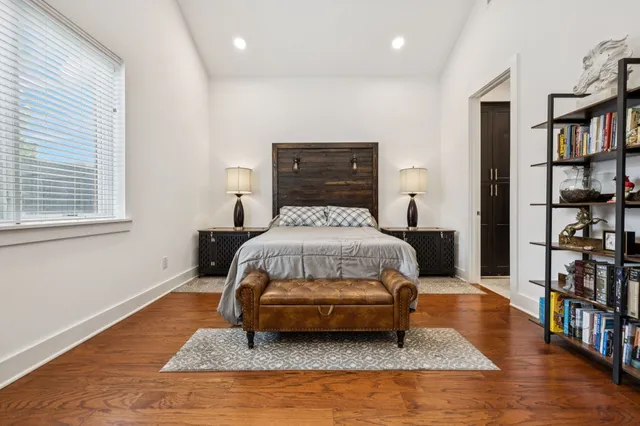 a bedroom with a bed and a book shelf